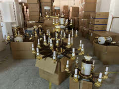 Chandelier parts and finishes staged for assembly